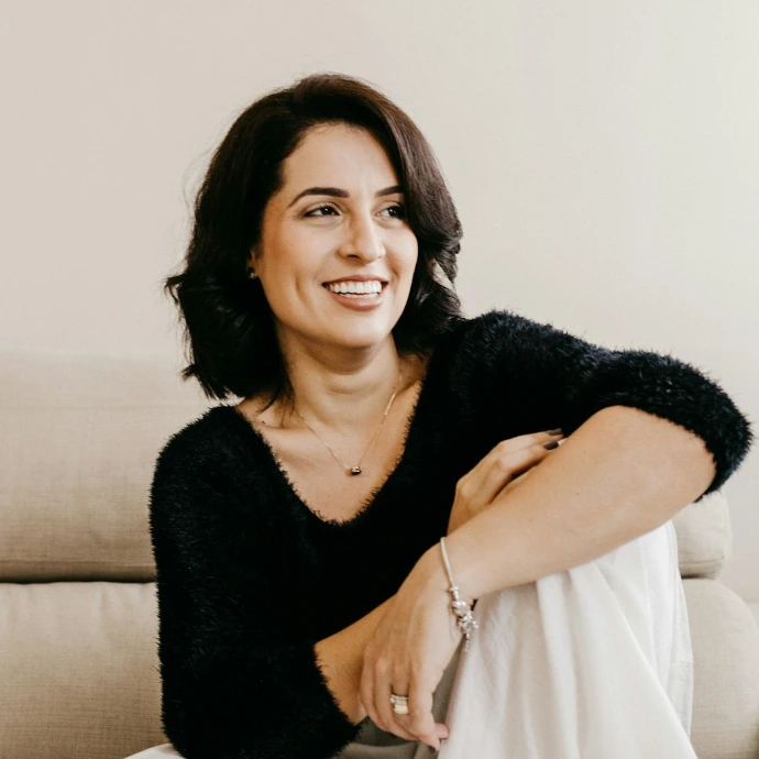woman in black long sleeve shirt sitting on white couch